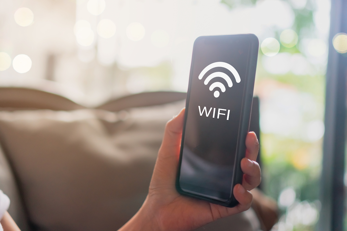 Wifi sign icon and connection screen of smartphone with top view city background. Financial business technology freedom dream life.
