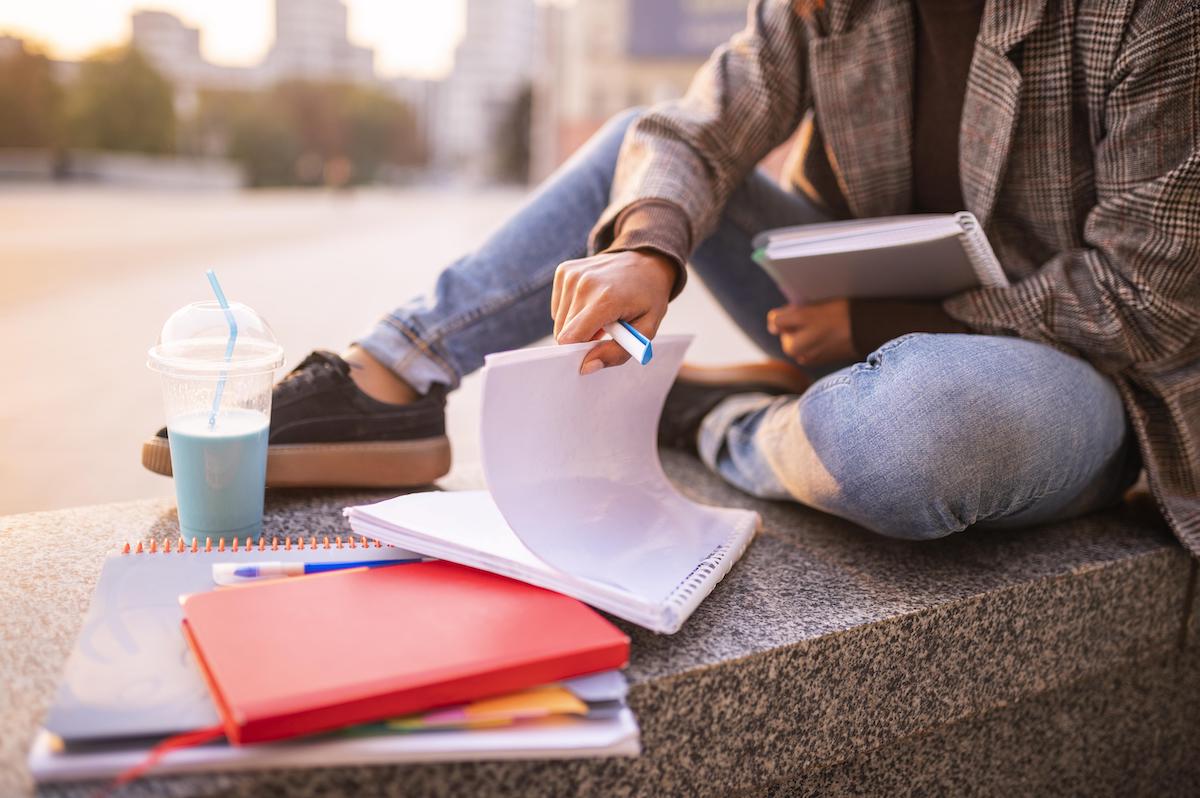 woman-doing-homework-outdoors-city